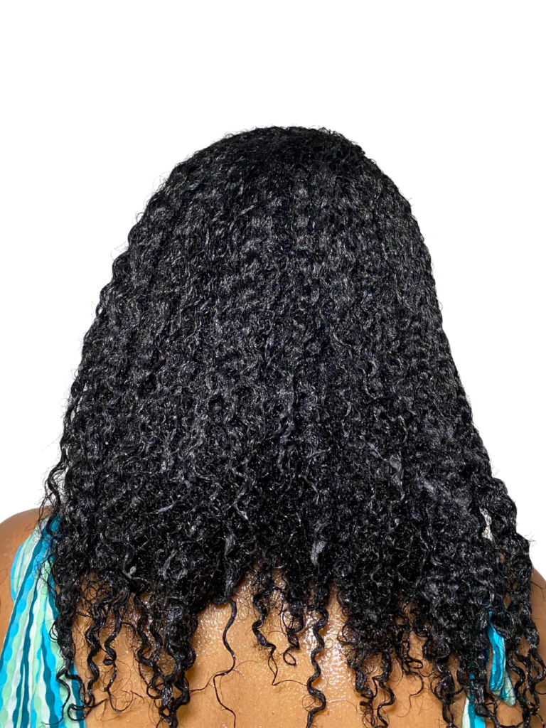 Woman with 4A hair showing curls reverting after a stretched style.